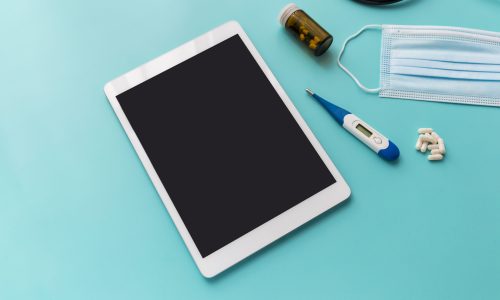 Medical background with blank tablet, thermometer, stethoscope and medicine, mockup